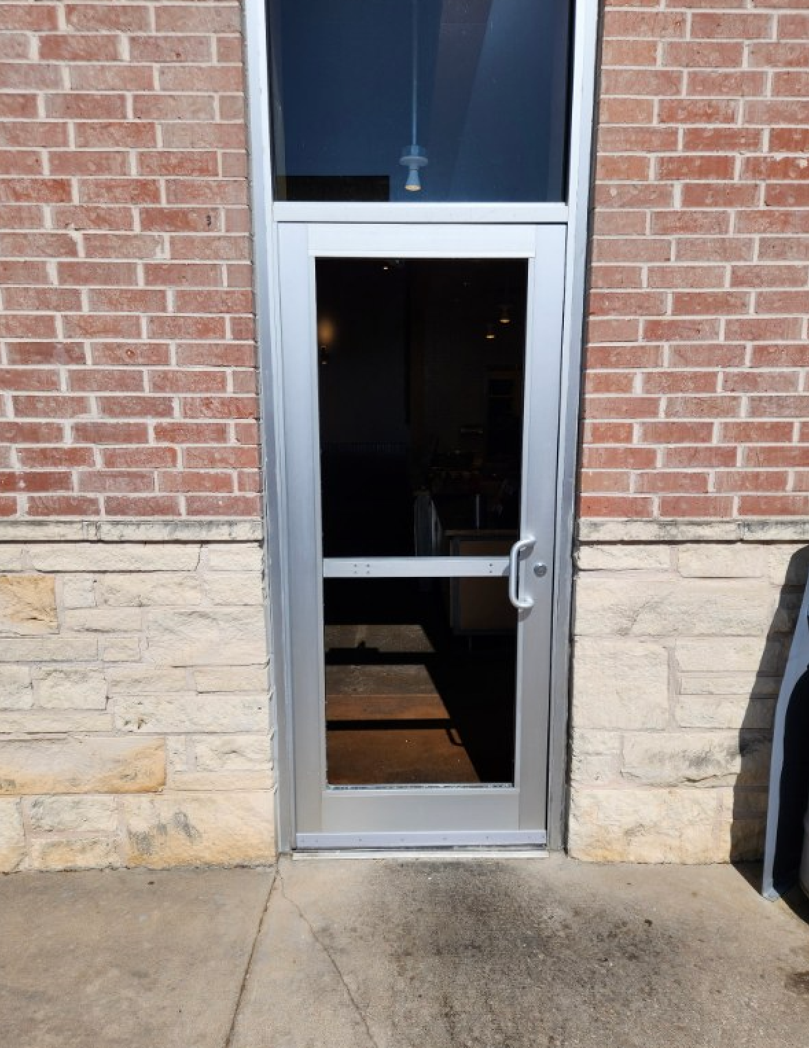 A brick building with a sliding glass door