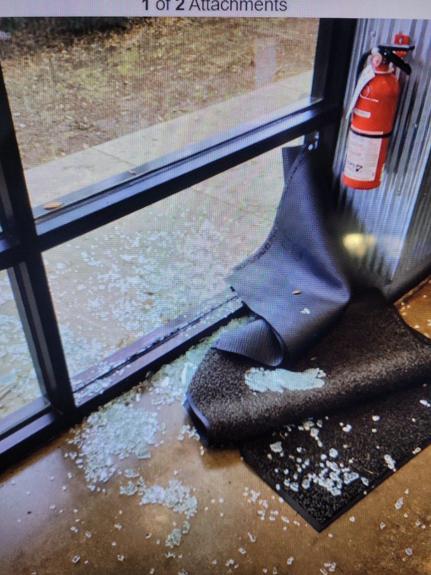 A fire extinguisher is hanging on a wall next to a window