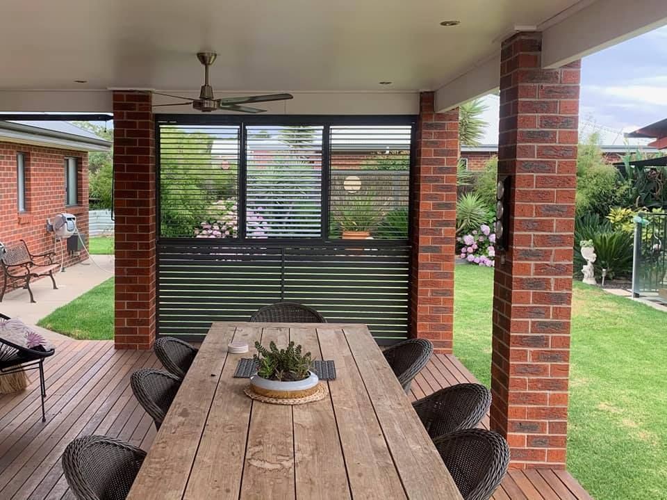 There is a large wooden table and chairs on the deck.