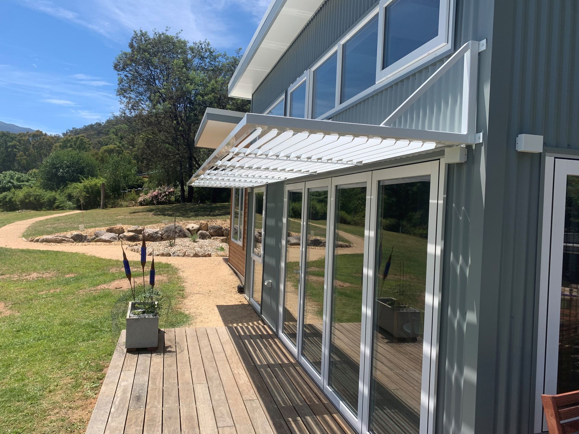 An aerial view of a house with a glass roof and a patio.