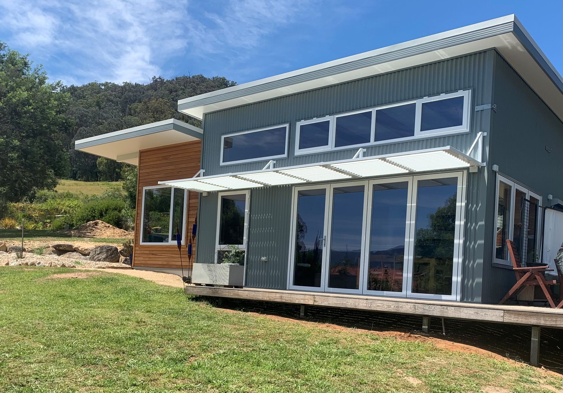 A black fence is sitting in front of a brick house.
