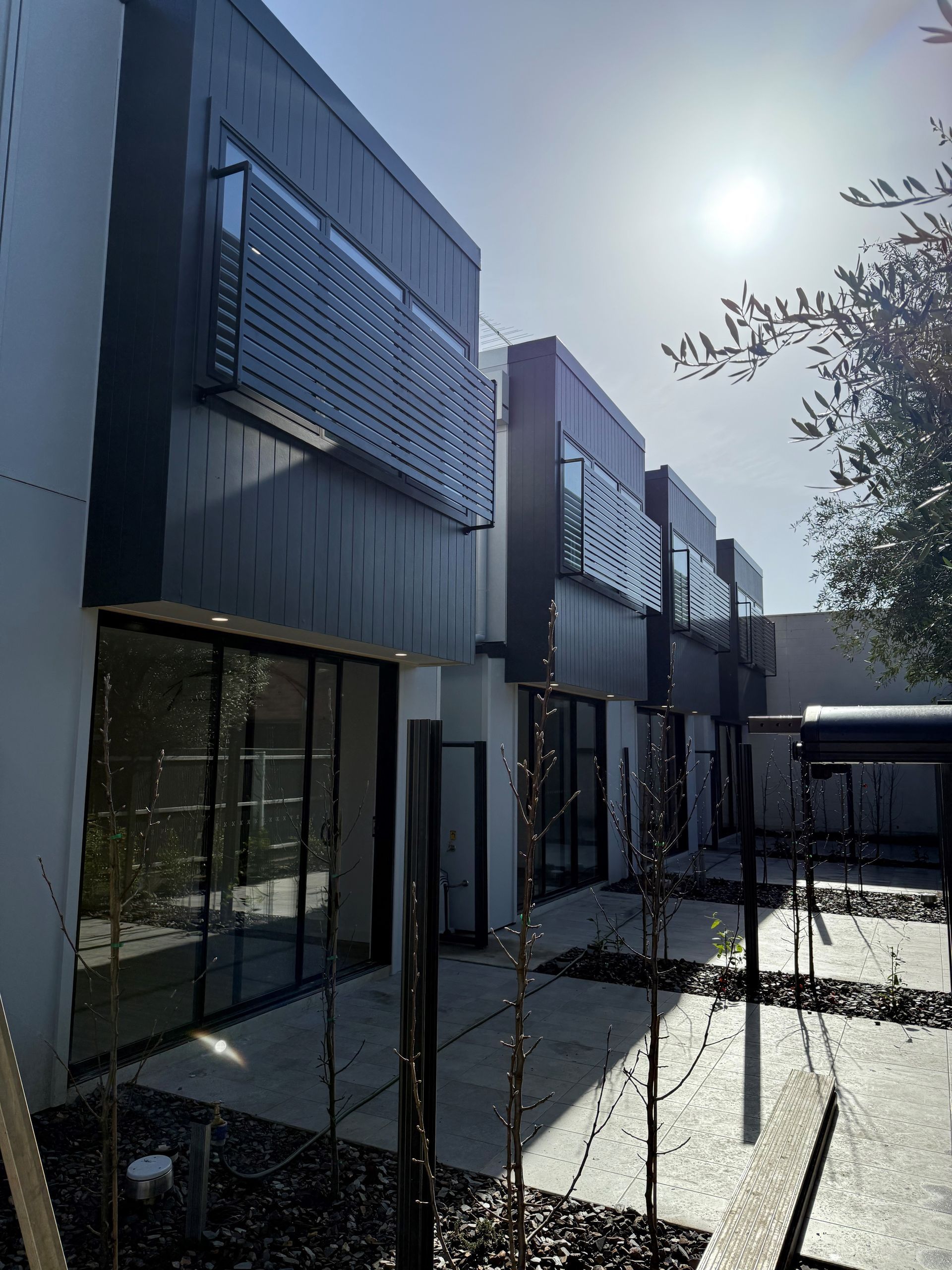 A window with a view of a tree with yellow leaves.