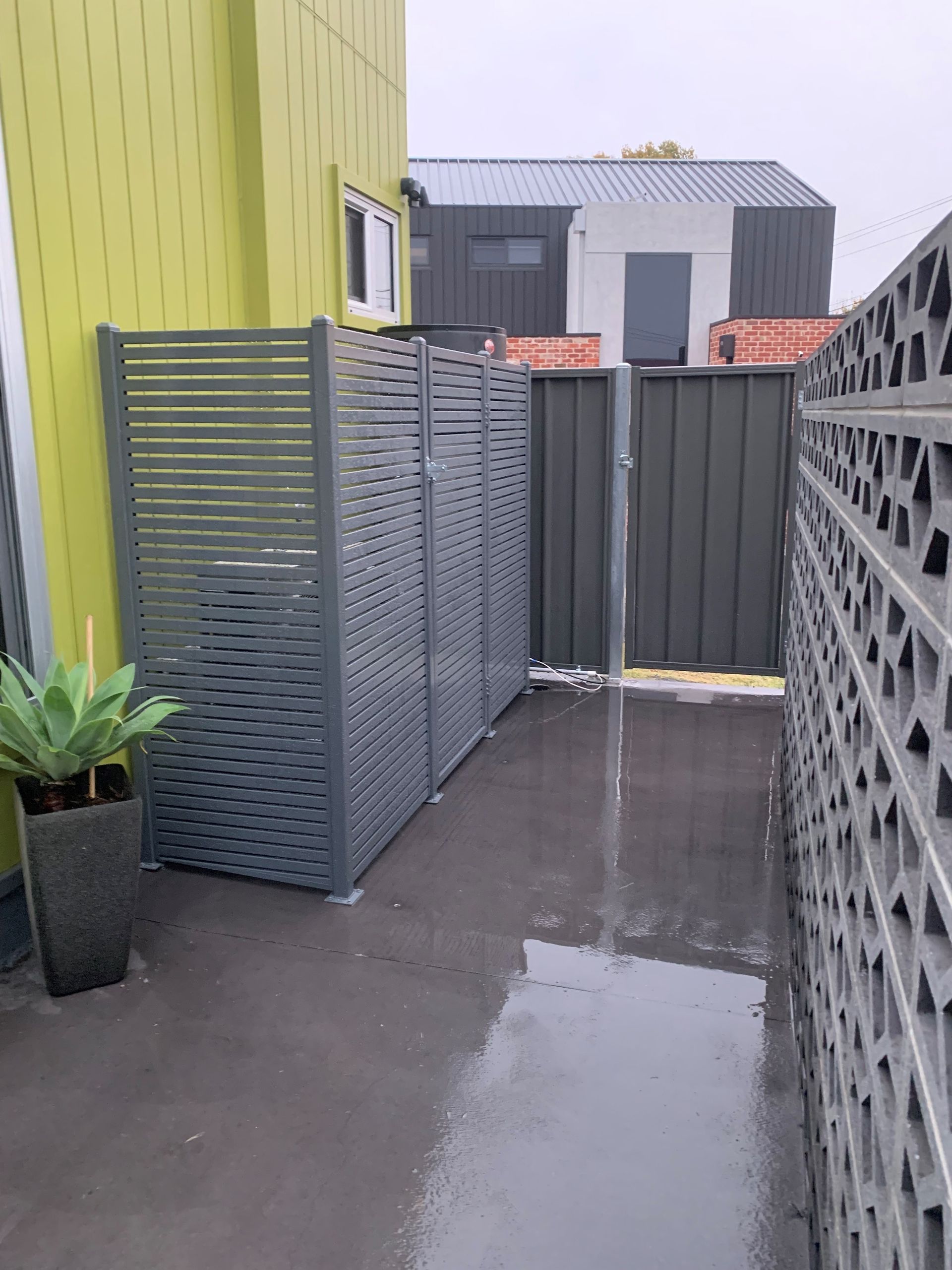 A white building with brown shutters on the windows