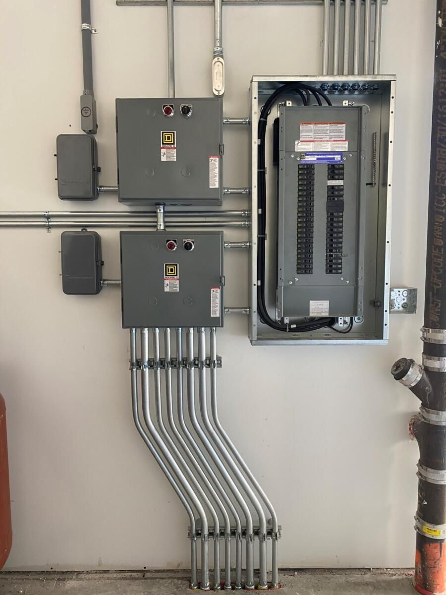 A electrical box with a lot of wires coming out of it.