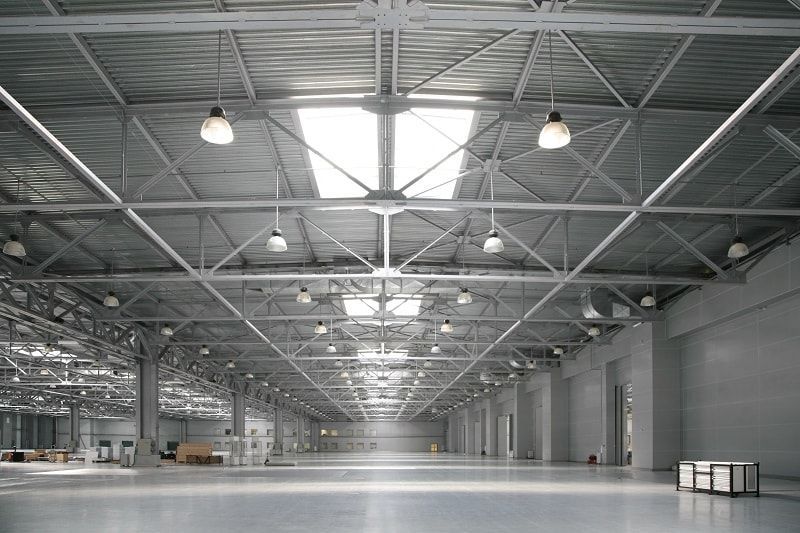A large empty warehouse with a skylight in the ceiling.