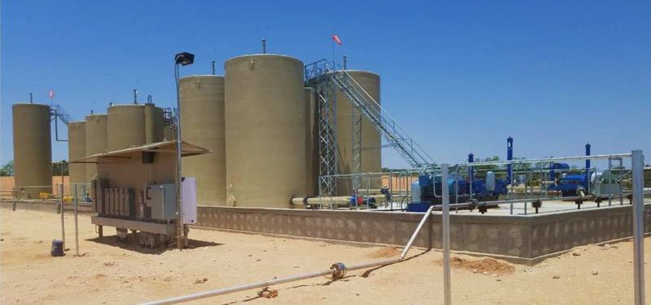 There are a lot of tanks in the middle of the desert.