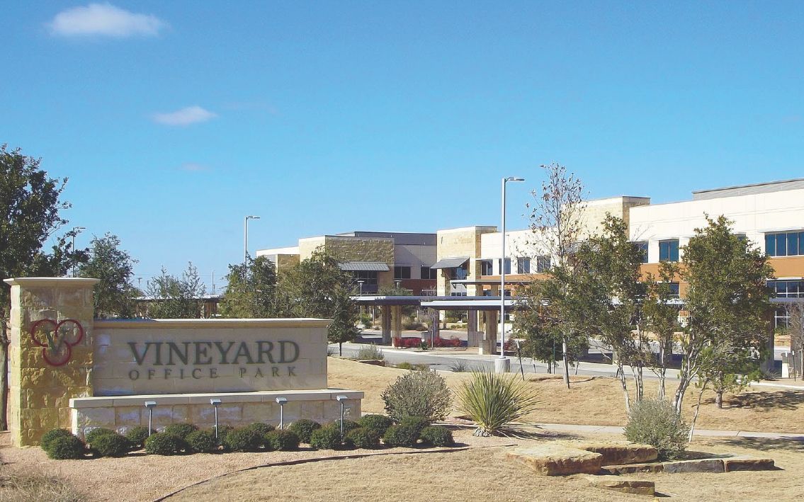 A large building with a vineyard office park sign in front of it