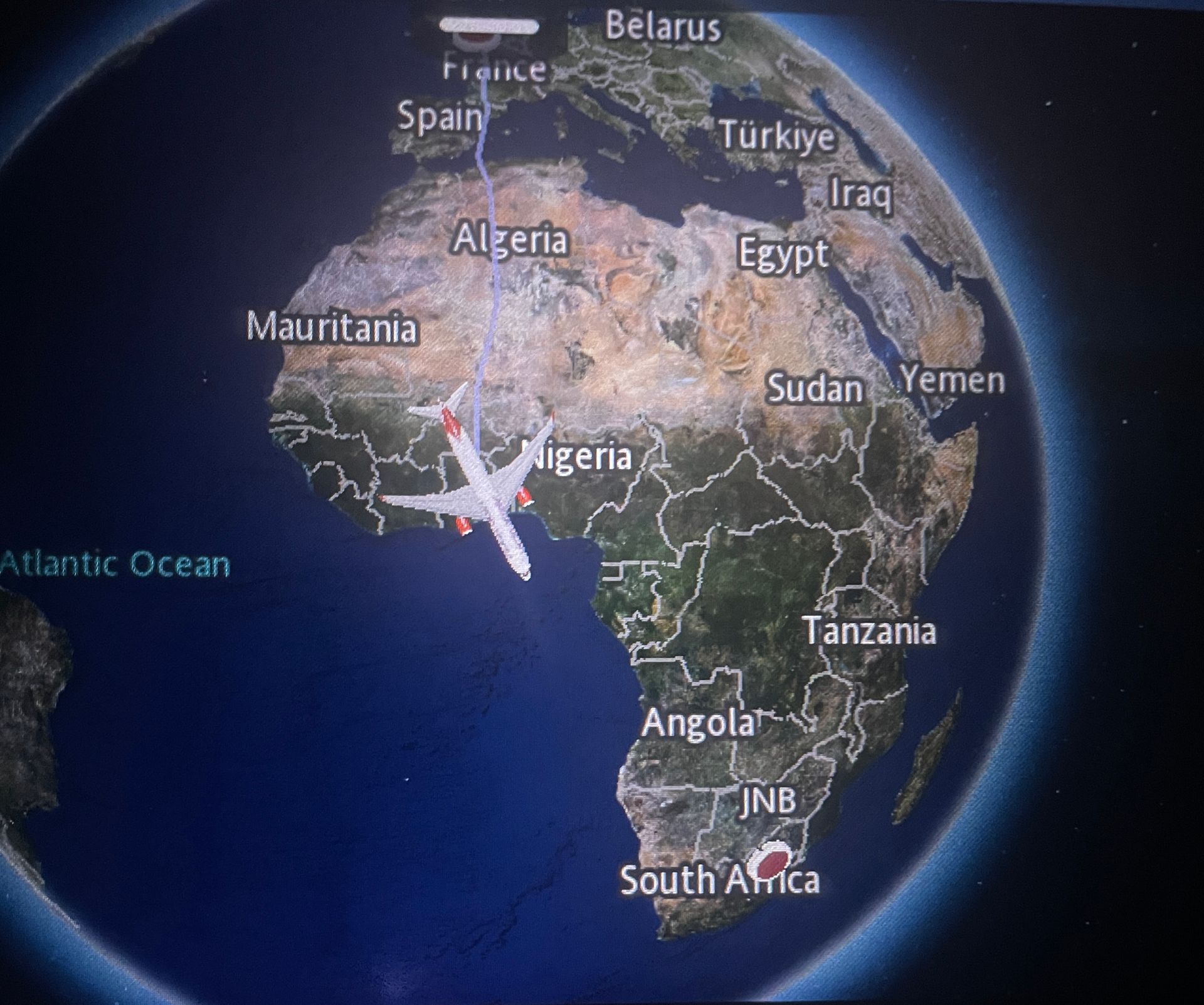 An airplane is flying over a map of africa