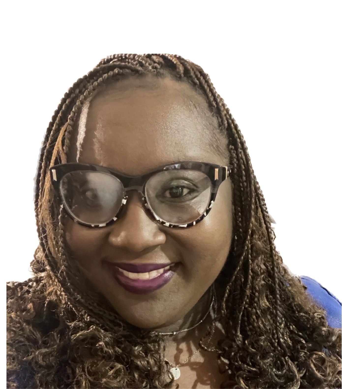 A woman with braids and glasses is smiling for the camera.