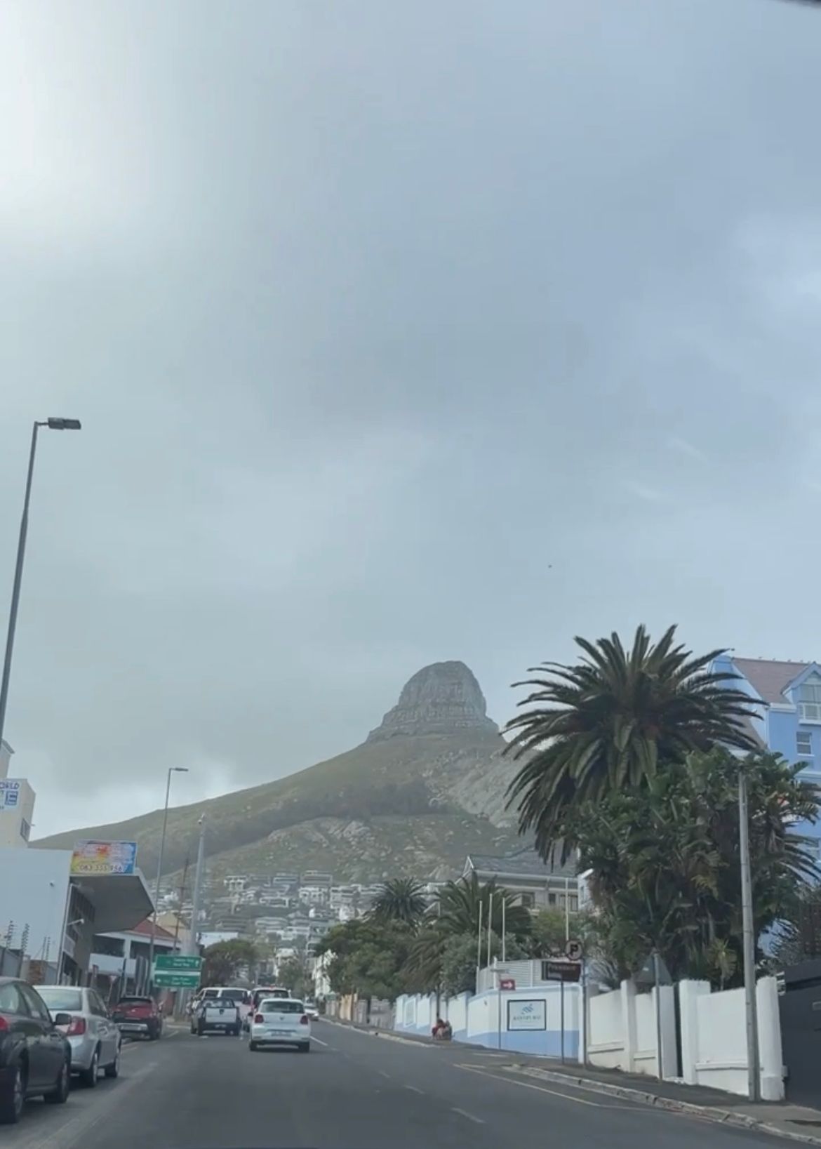 A city street with a mountain in the background