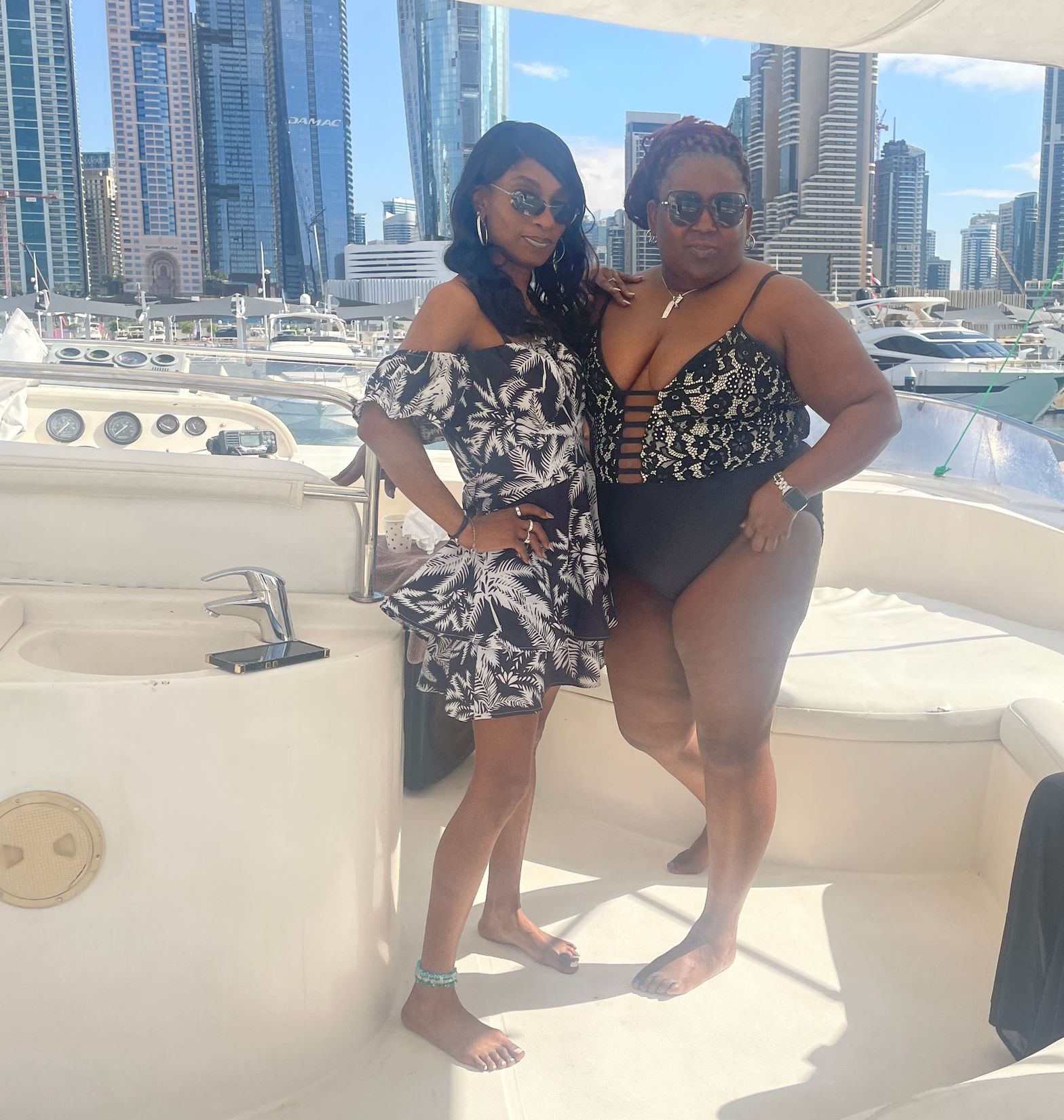 Two women are posing for a picture on a boat