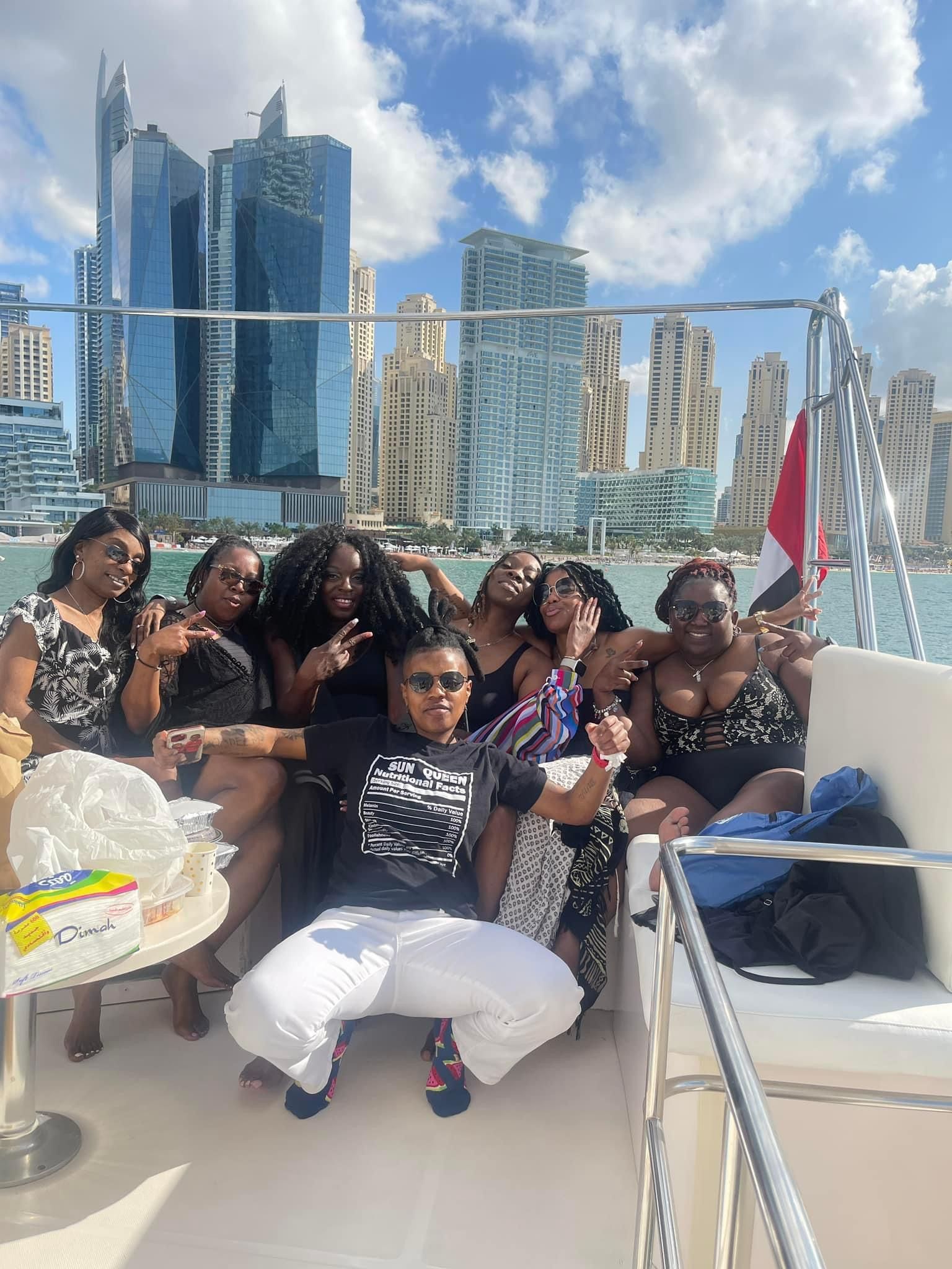 A group of women are posing for a picture on a boat.
