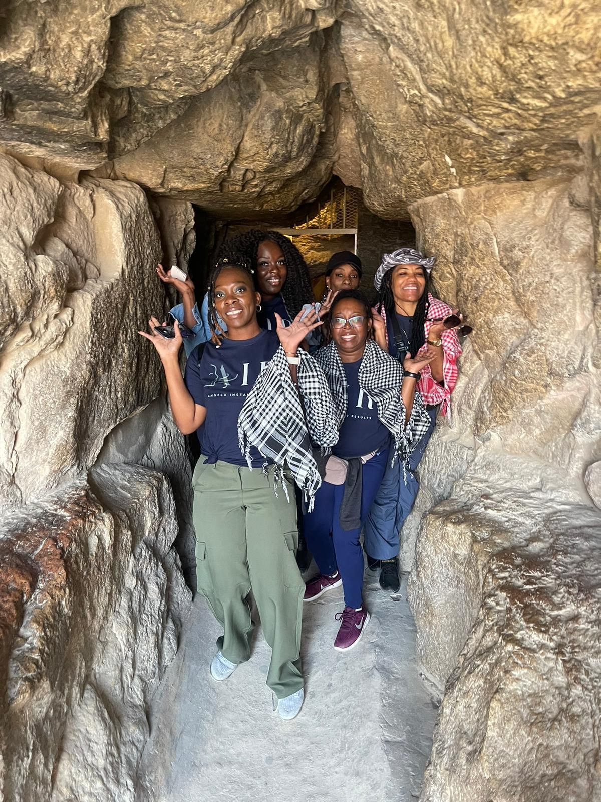 A group of people are standing in a cave.