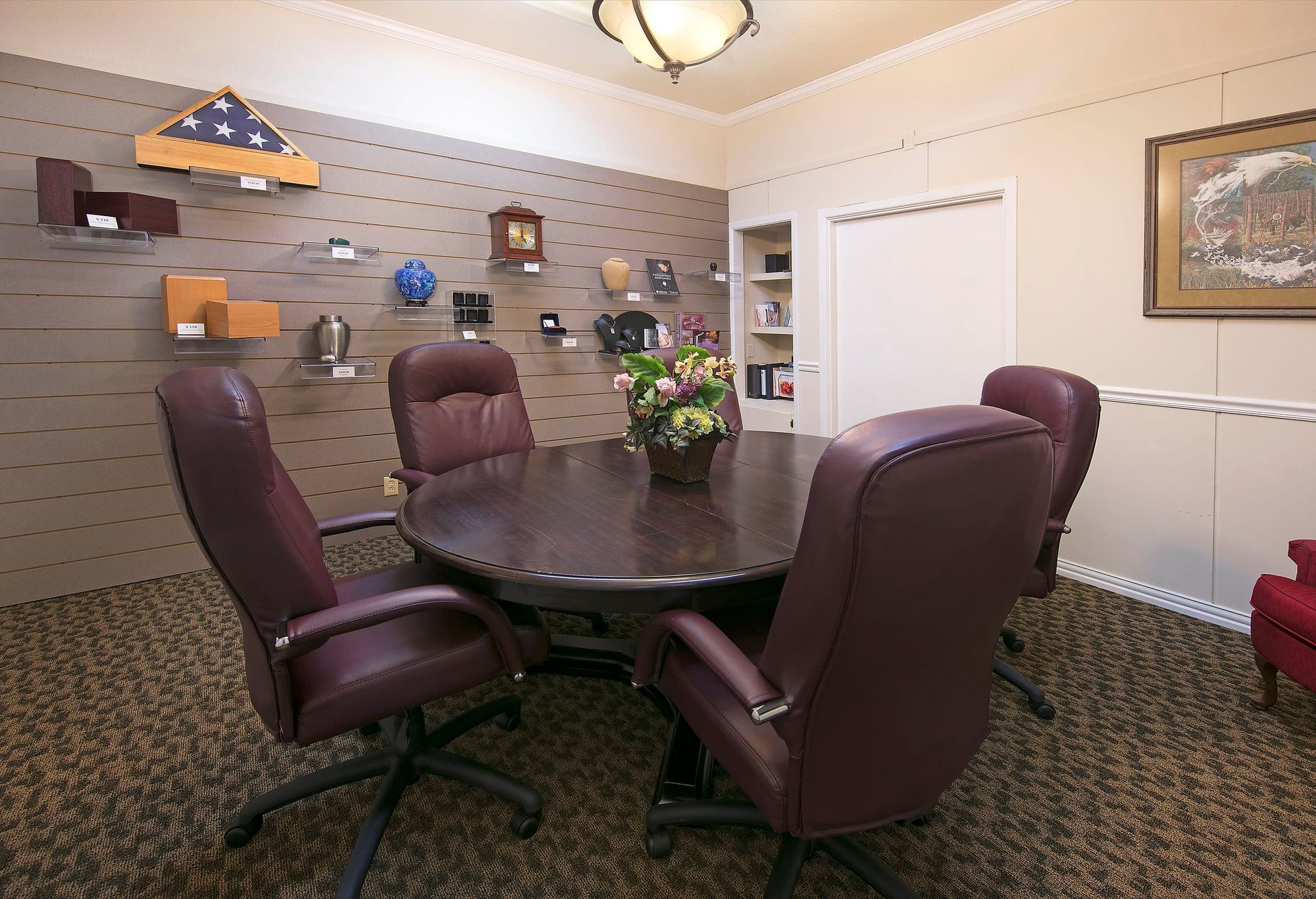 A conference room with a round table and chairs