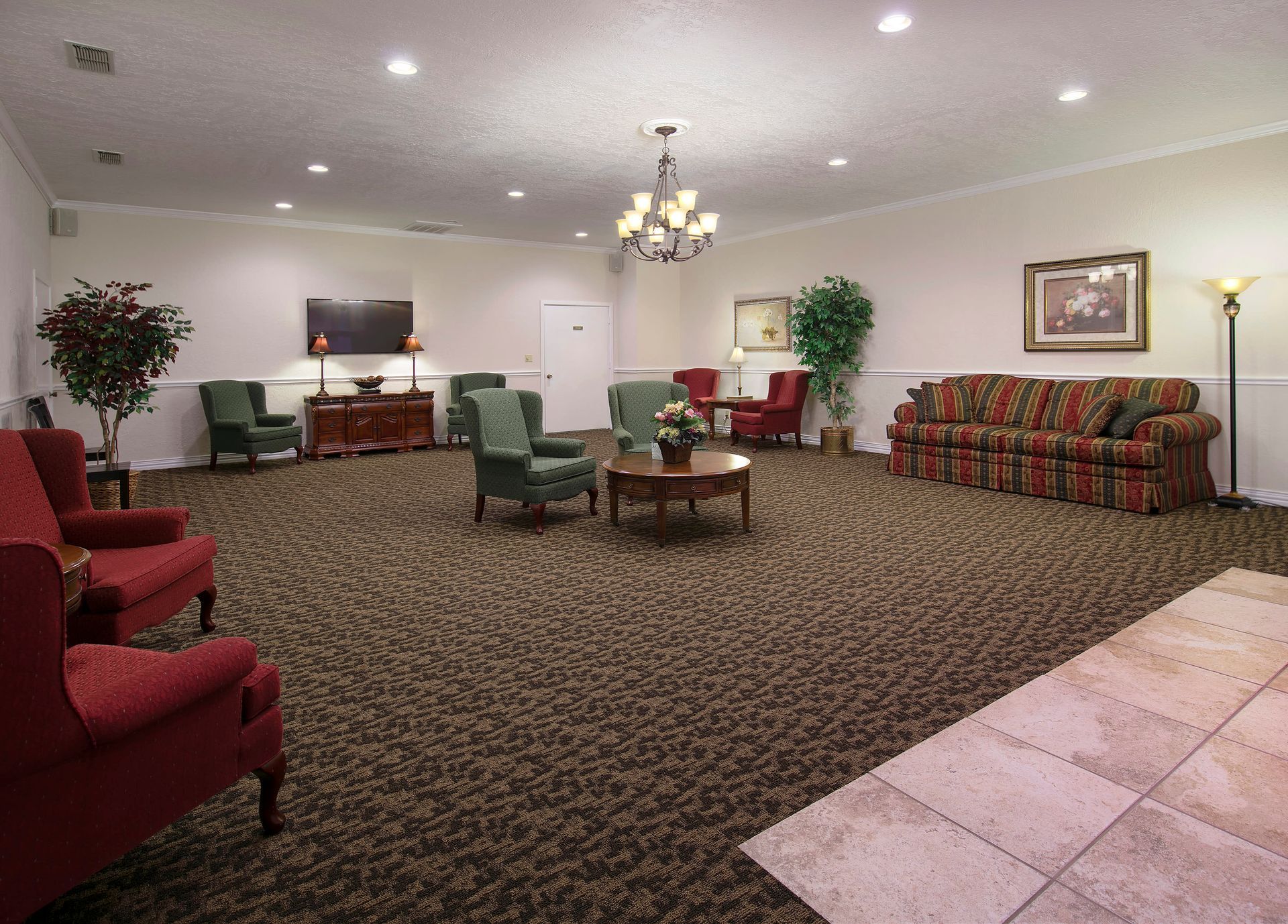 A large room with a couch and chairs in it