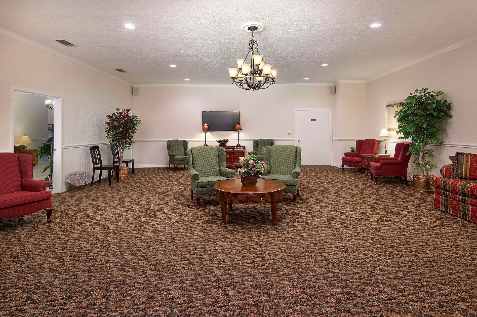 A living room filled with furniture and a chandelier.
