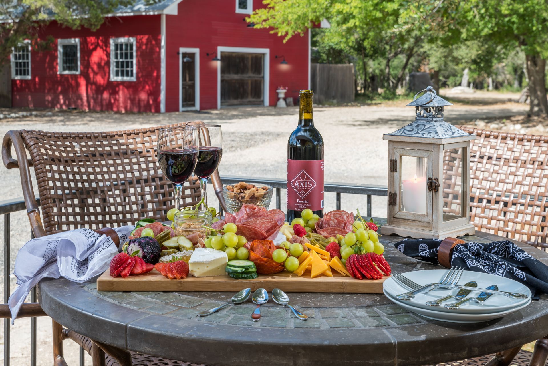 A table with a tray of food and a bottle of wine on it.