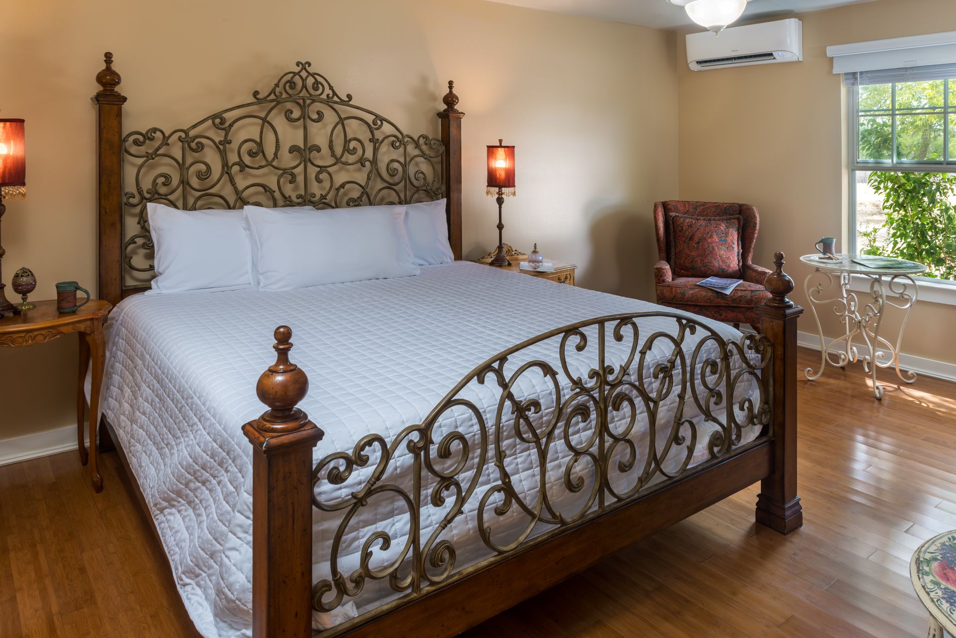 A bedroom with a king size bed and a chair.