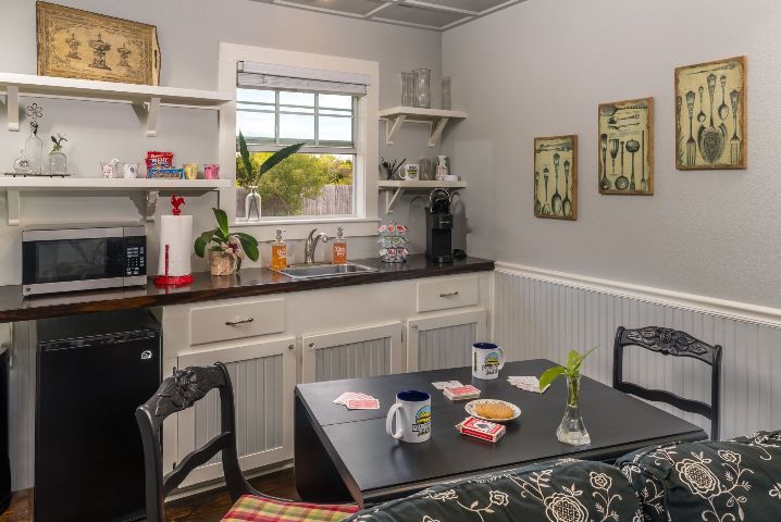 A kitchen with a table and chairs and a sink.