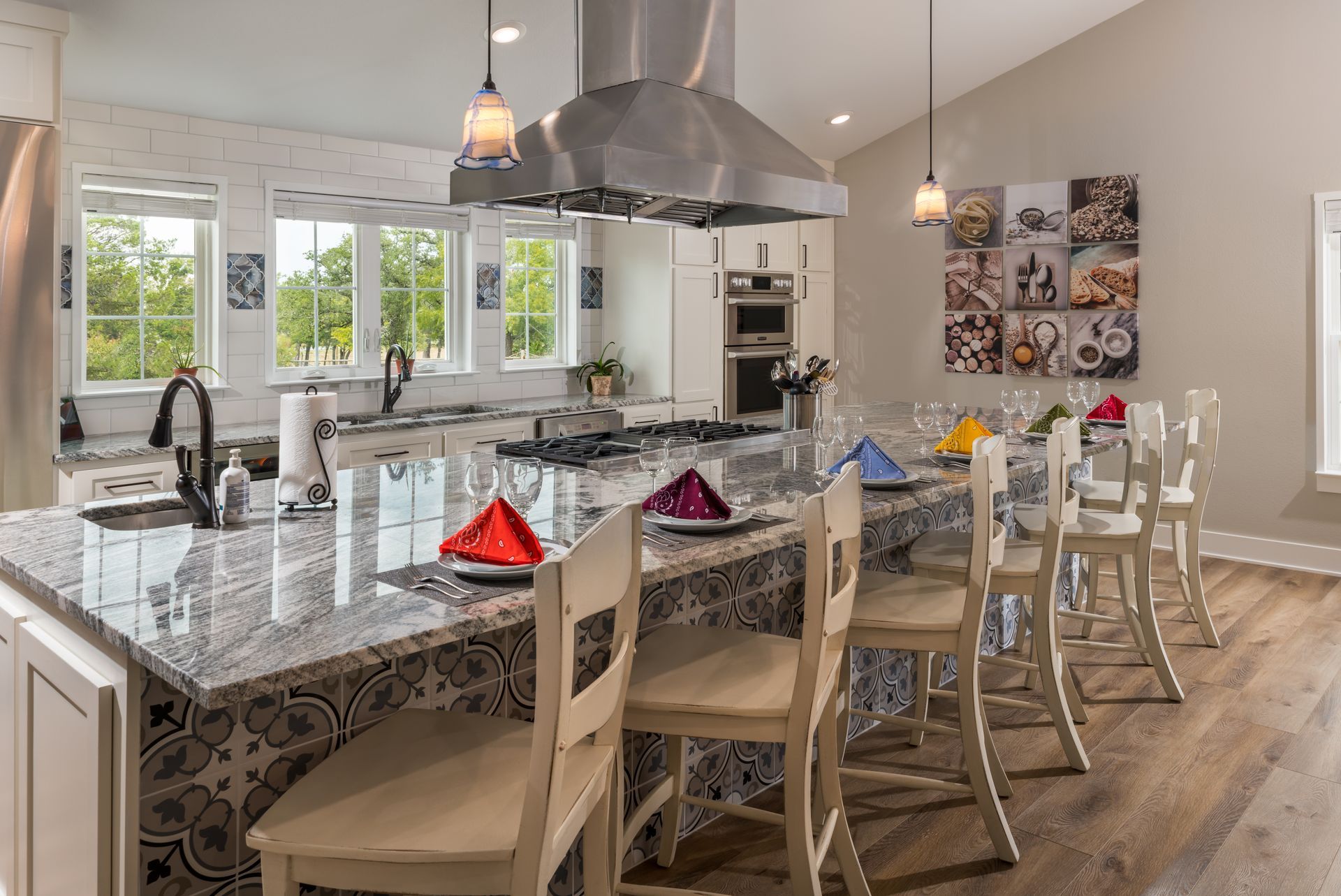 A kitchen with a large island and a stove top oven.