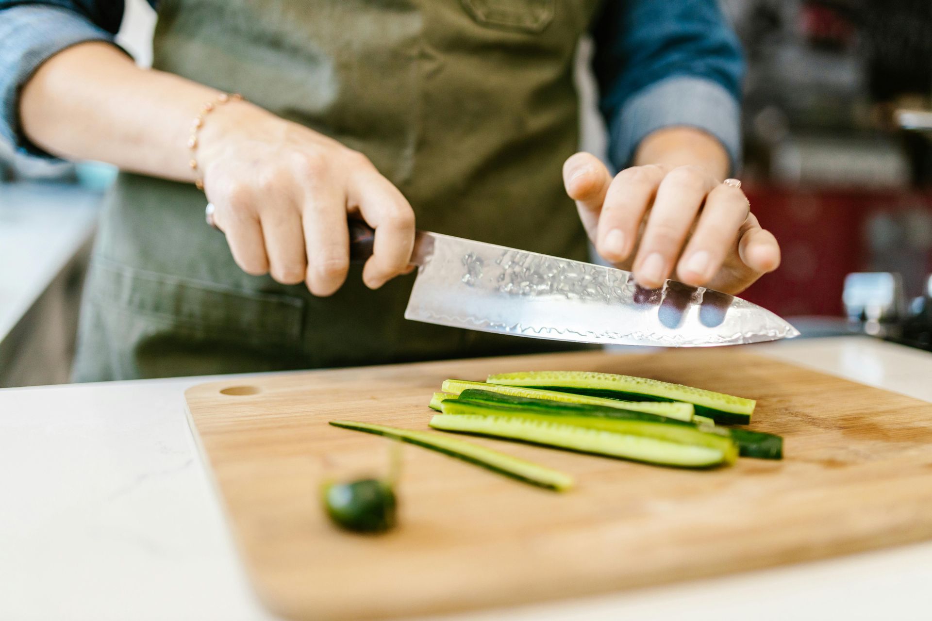a woman cutting vegetables on a cutting board
