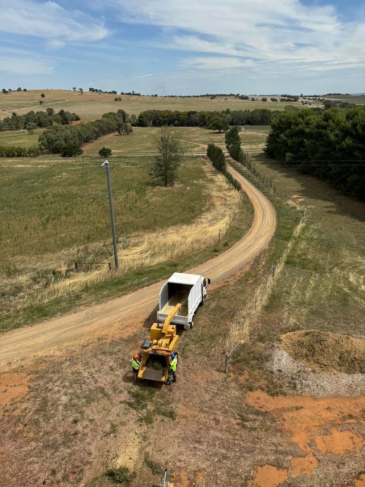 Truck Hauling Equipment on Dirt Road Through a Rural Landscape — Riverina Tree Fellas in Gobbagombalin, NSW