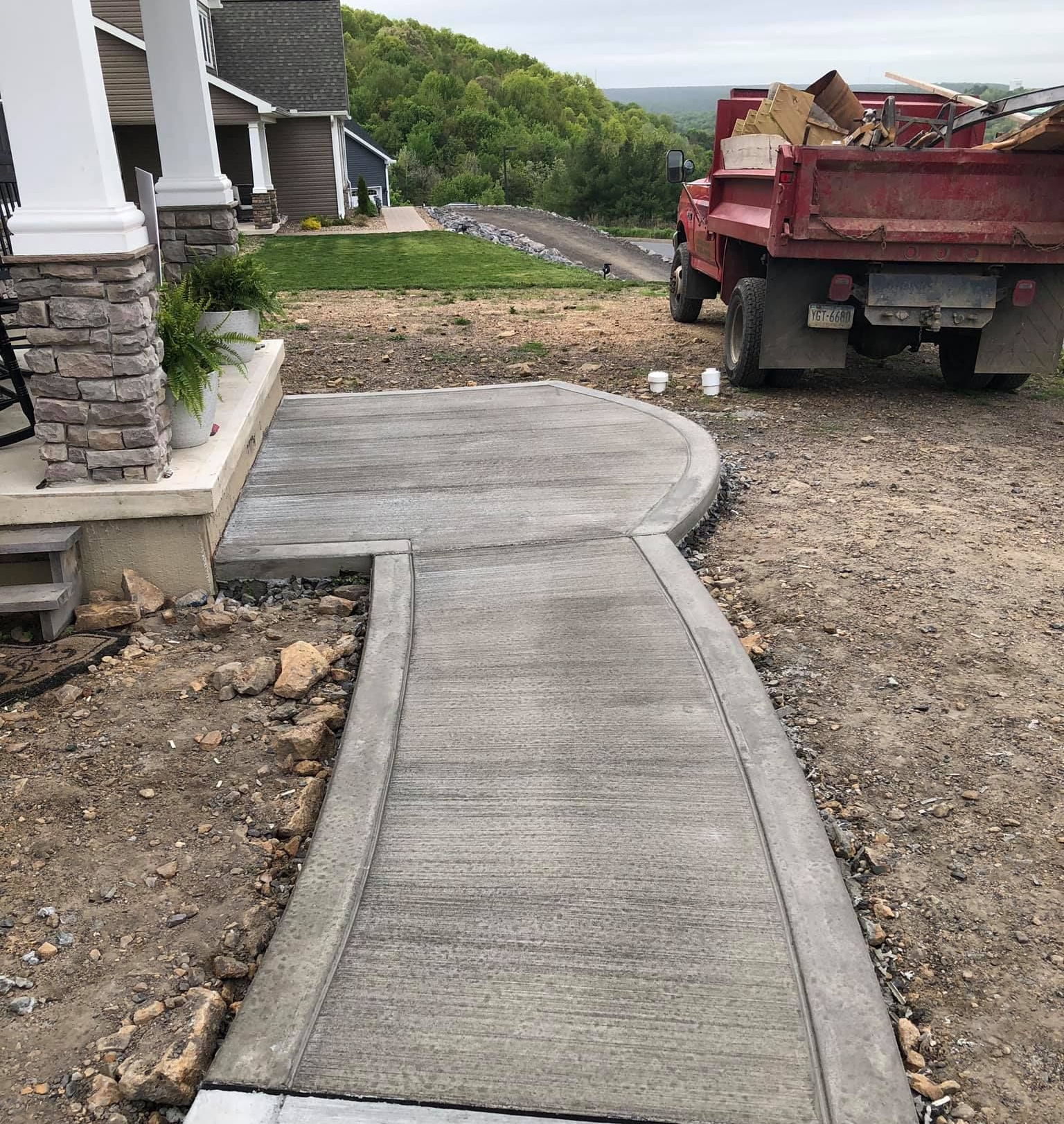 Concrete walkway installation with site preparation