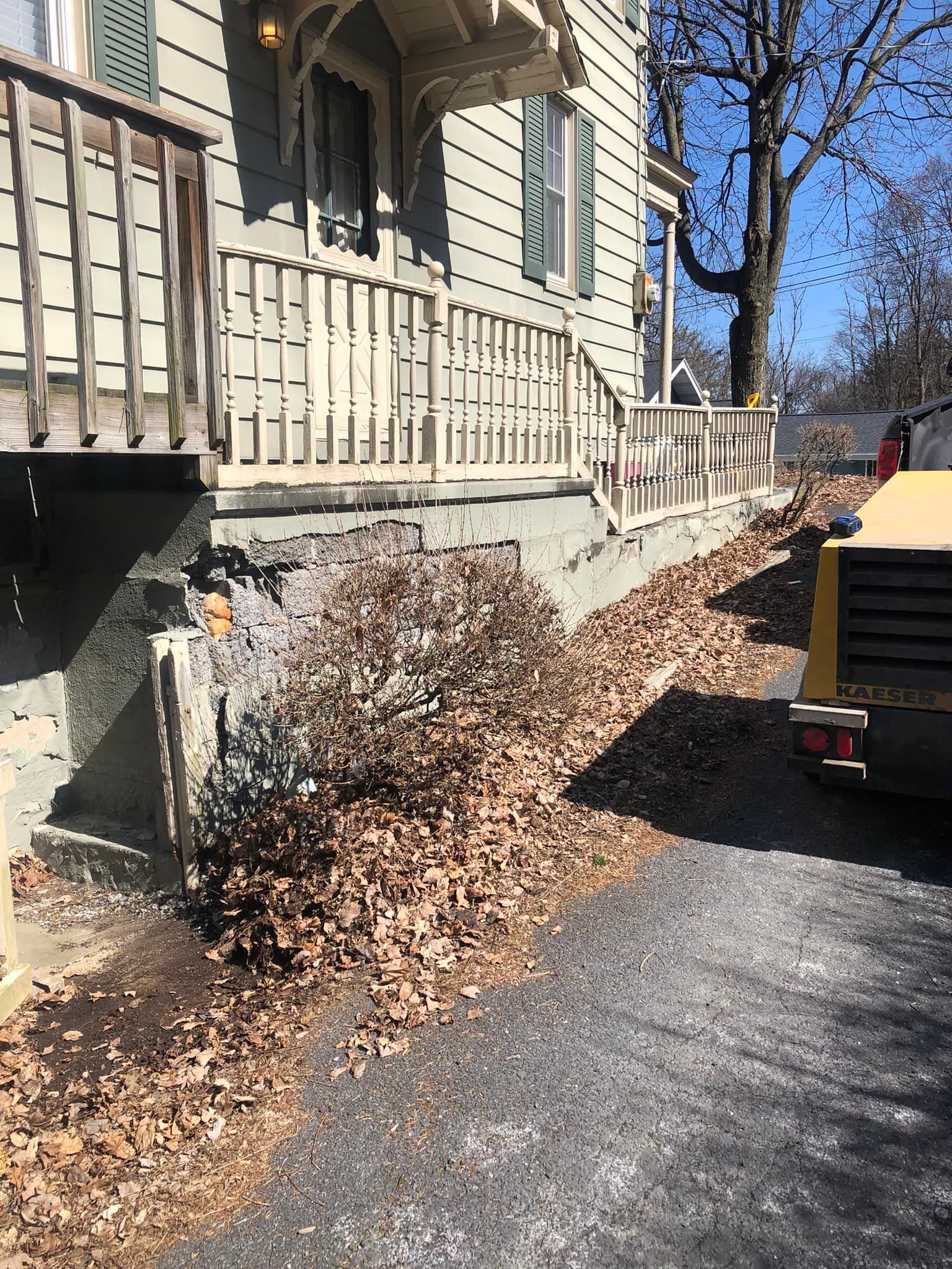 Concrete foundation work along residential porch