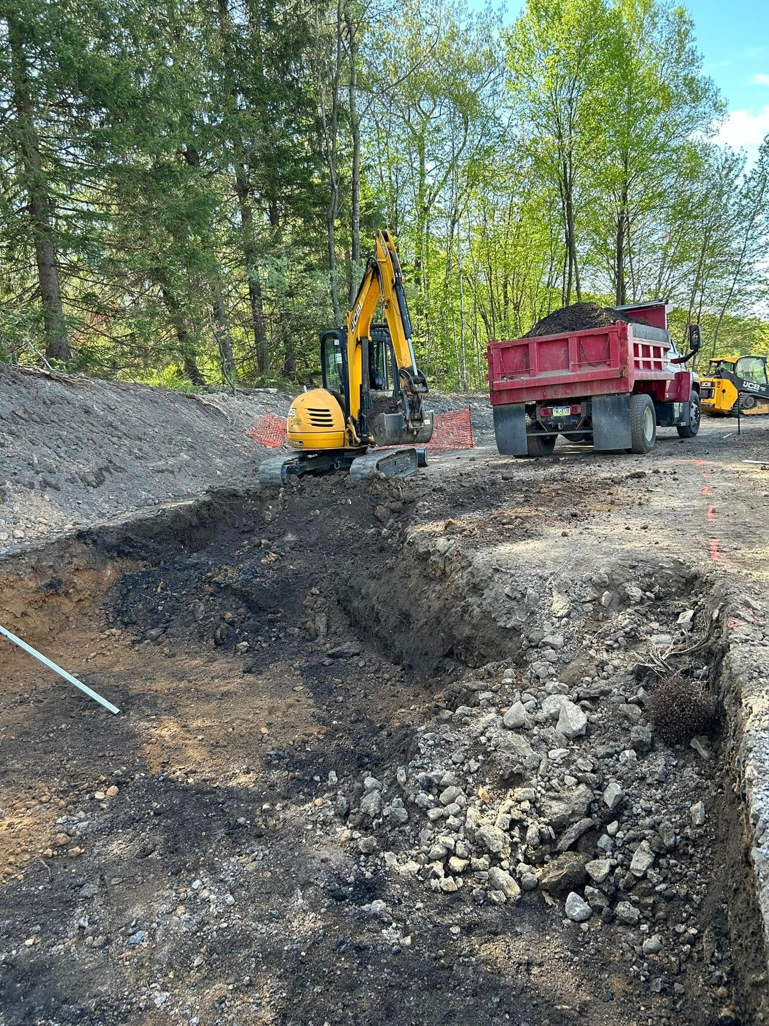 Excavator and dump truck performing site excavation work