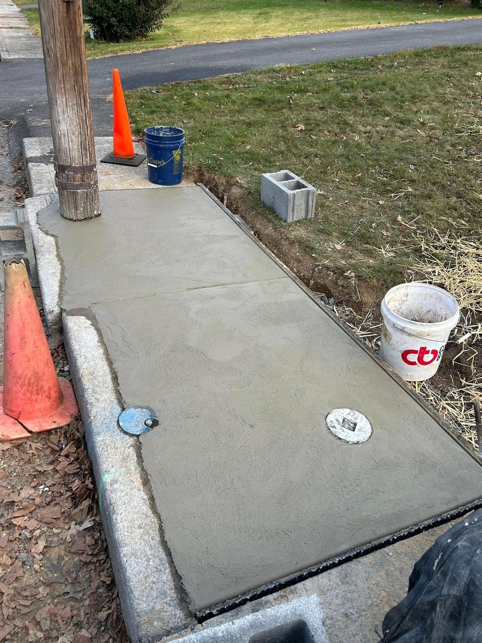 Concrete pad installation around utility pole
