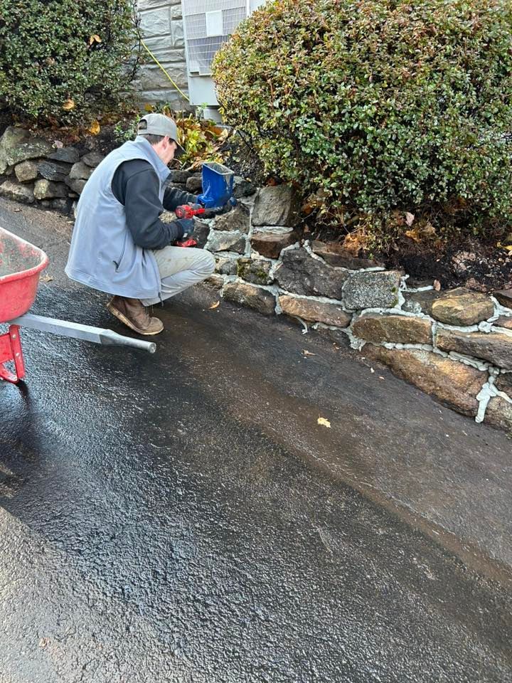 Retaining wall repair work along residential landscape