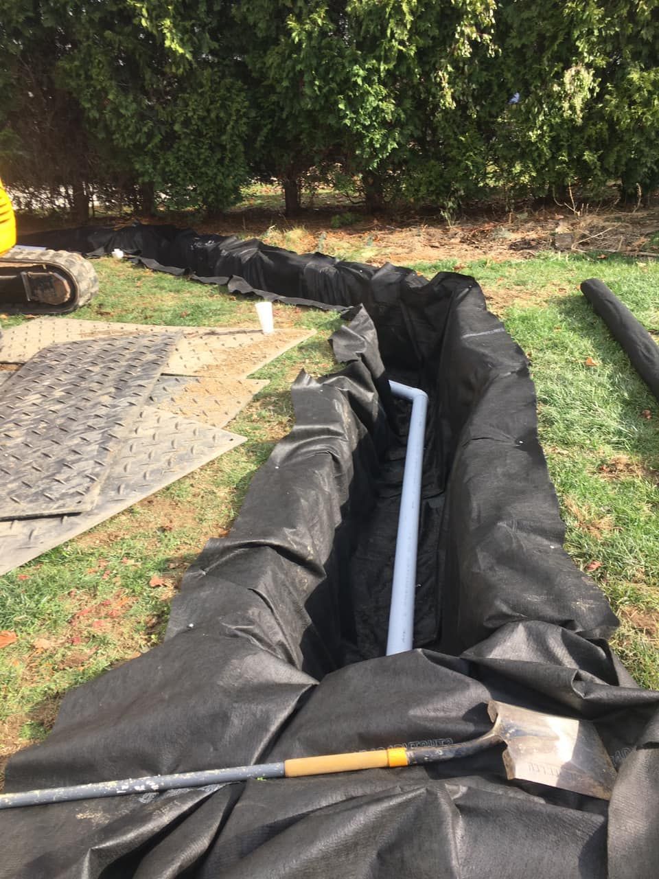 Excavated trench with protective liner installed