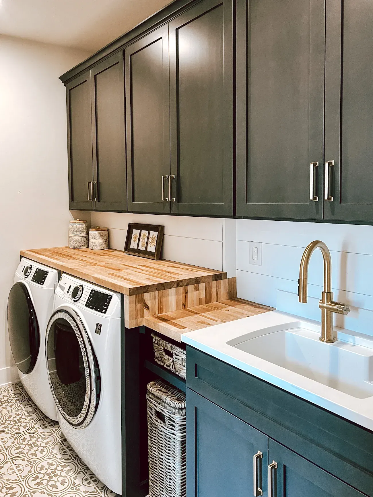 A laundry room with a washer and dryer and a sink.