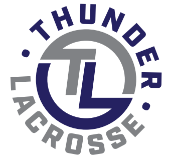 Baseball glove with ball on green grass, with blurred baseballs in the background.