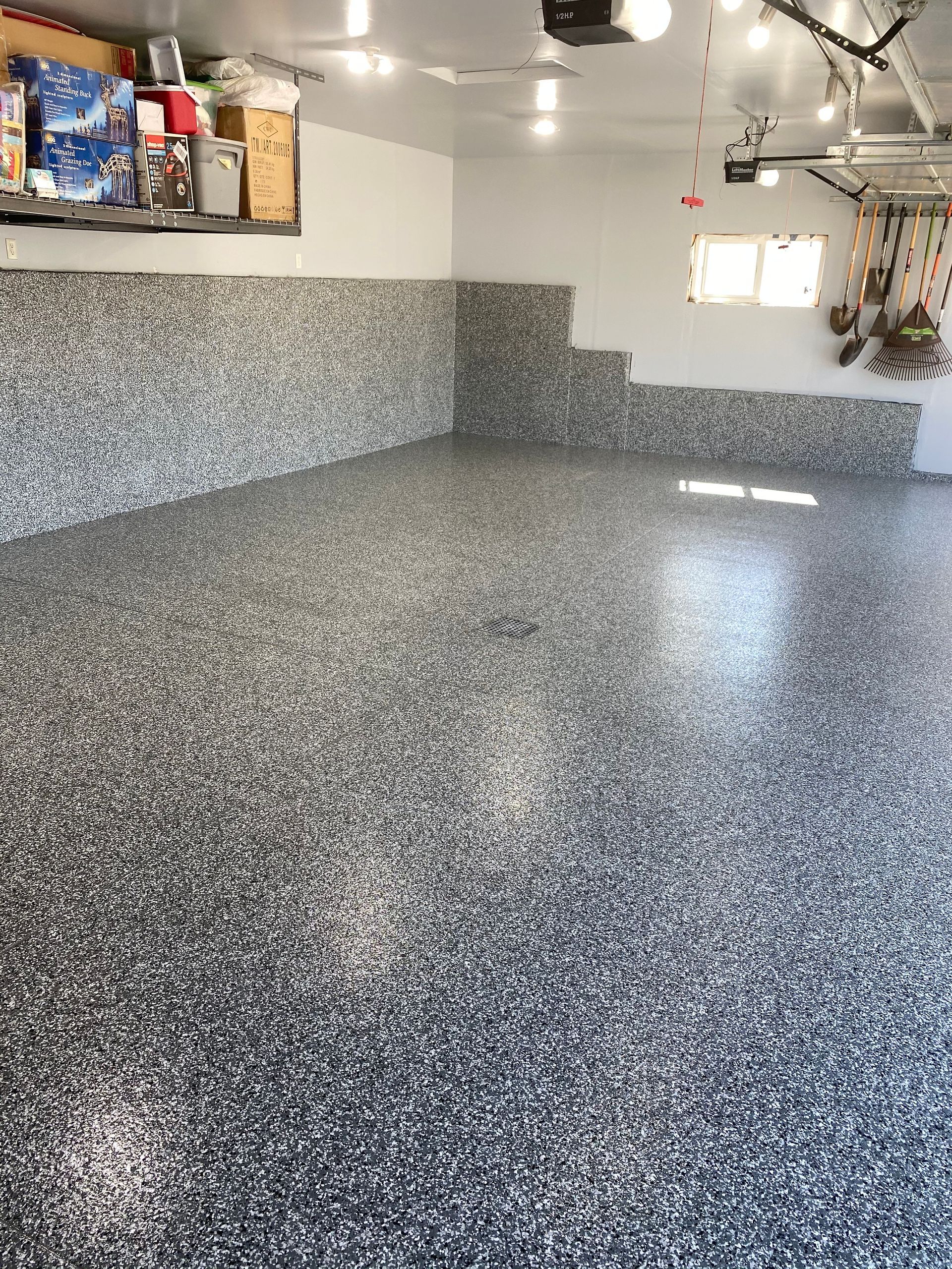 A garage with a gray floor and white walls.