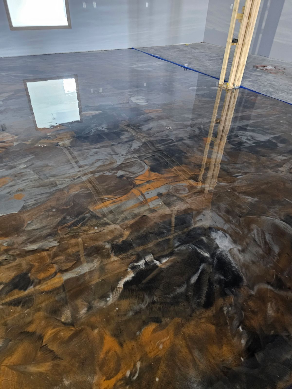 A close up of a shiny metallic floor in a room.