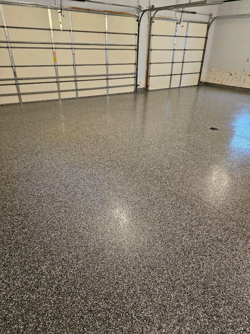 A garage with a shiny floor and two garage doors.