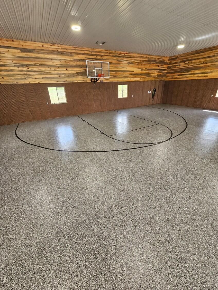 There is a basketball court in the middle of the room.