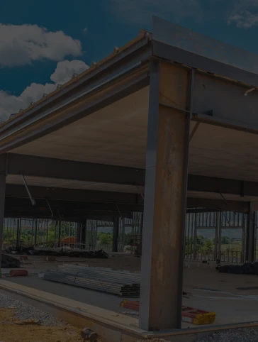 A building under construction with a wooden roof and a metal frame.