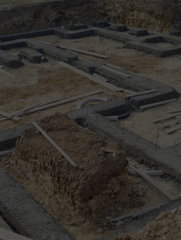 A construction site with a lot of dirt and concrete.