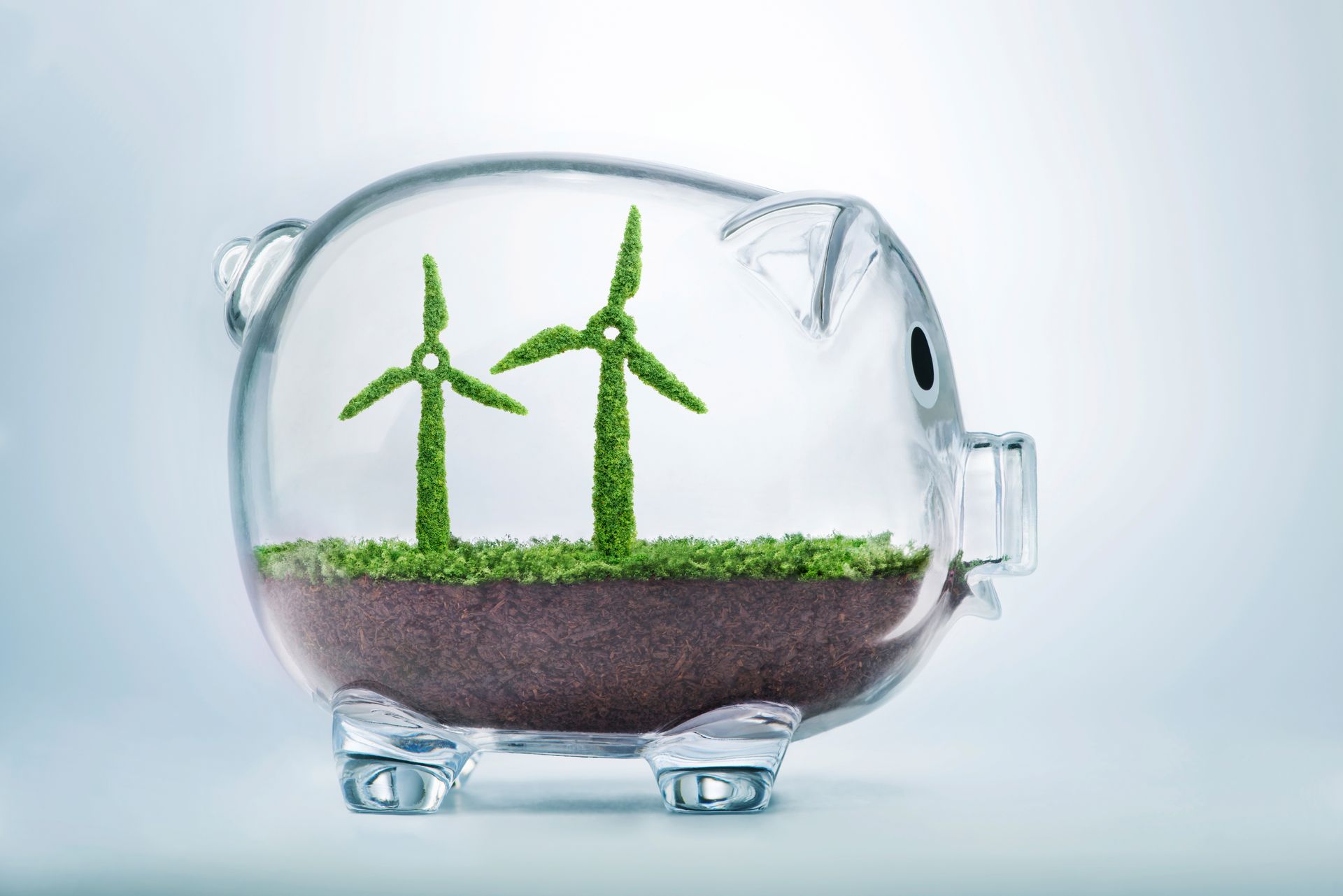 A piggy bank with two wind turbines inside of it.