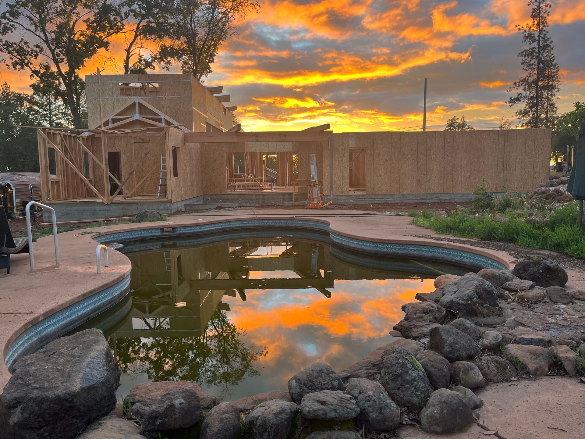 A house under construction with a swimming pool in front of it in Paradise and Magalia, California.