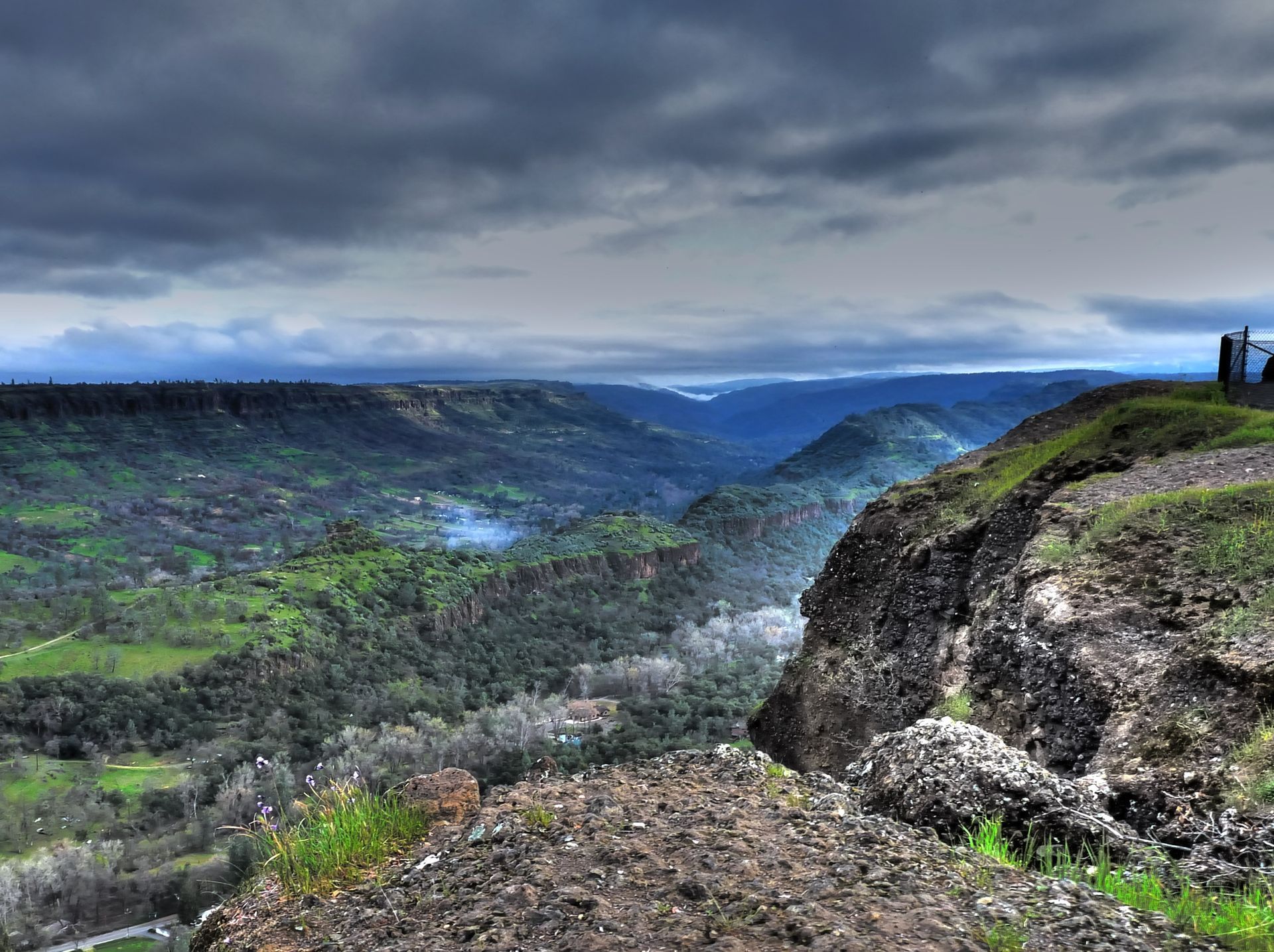 People standing on top of a cliff at Paradise and Magalia, California.