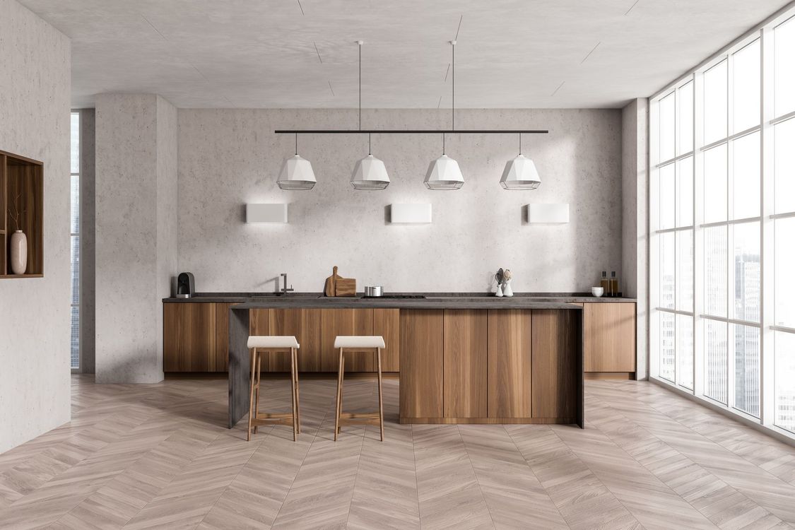Modern kitchen with wooden cabinets, island, and bar stools. Large windows provide natural light.