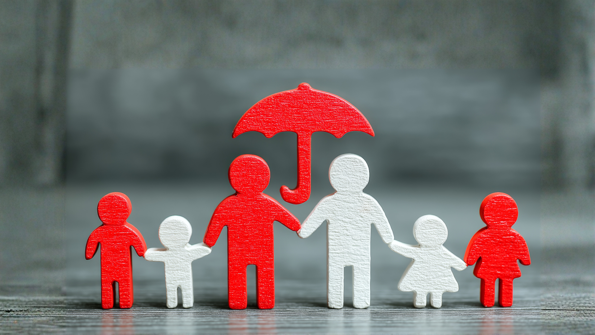Five paper figures holding hands under a red umbrella, with one figure standing apart in gray background