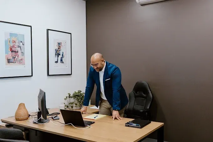 Three Women Are Standing Around A Computer In An Office — David Tamanika Solicitors in Ballarat Central, VIC