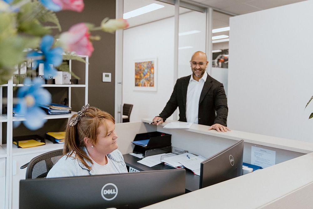 A Large White Building With A Lot Of Windows And Chimneys Is Surrounded By Trees — David Tamanika Solicitors in Ararat, VIC