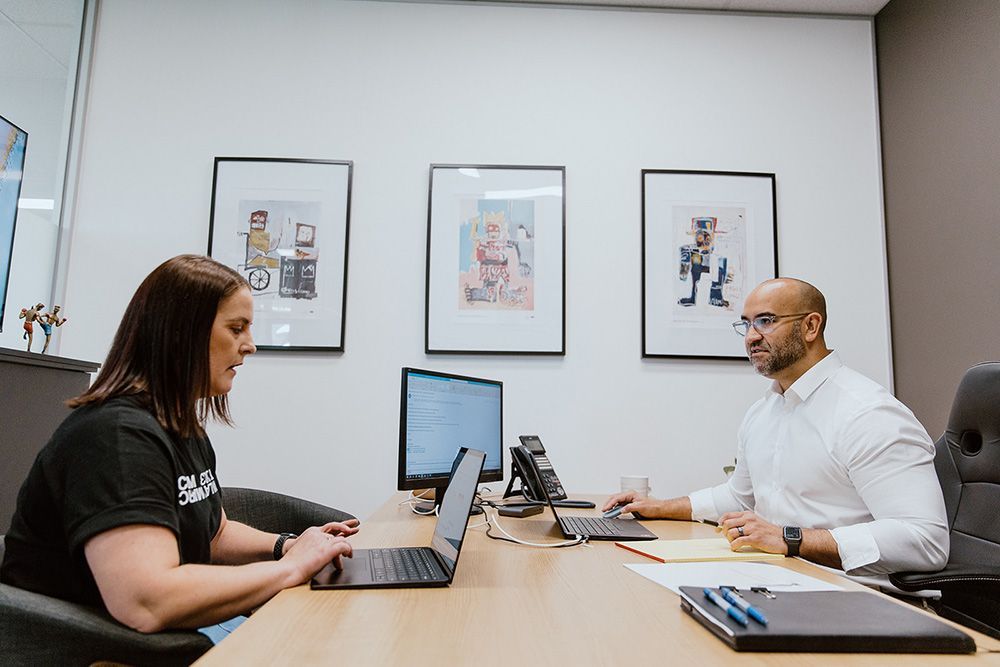 A Car Is Driving Past An Archway At Sunset — David Tamanika Solicitors in Ballarat, VIC