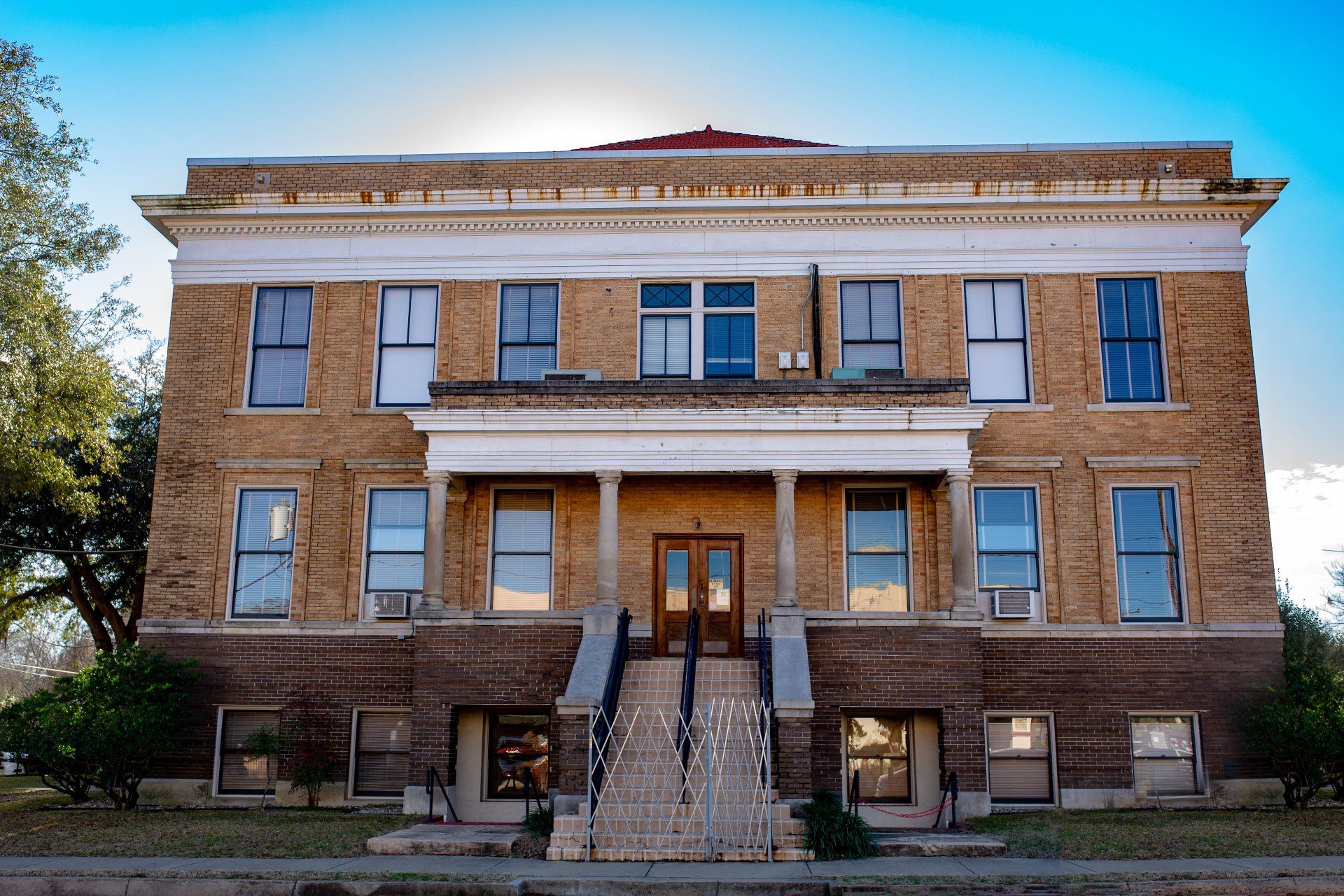 A large brick building with stairs leading up to it