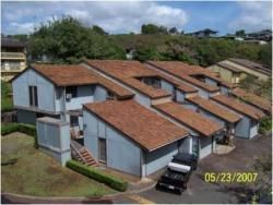 An aerial view of a row of houses on a sunny day.